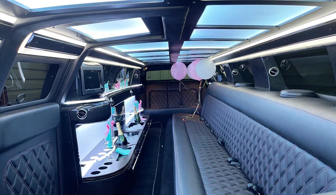 Luxurious stretch limousine interior with LED lights and plush seating for events like weddings and proms